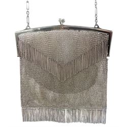 Continental Art Deco silver mesh purse with chain fringe, and carry chain stamped 925, the clasp opening to reveal a chamois leather lining, stamped 925,  also bearing import marks for Birmingham 1913, makers mark EGB, approximate gross weight 11.70 ozt (364 grams)
