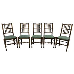 Set of five Lancashire design elm spindle back chairs, shaped cresting rail over two rows of five spindles, upholstered drop-on seats, on turned front supports united by turned stretchers  