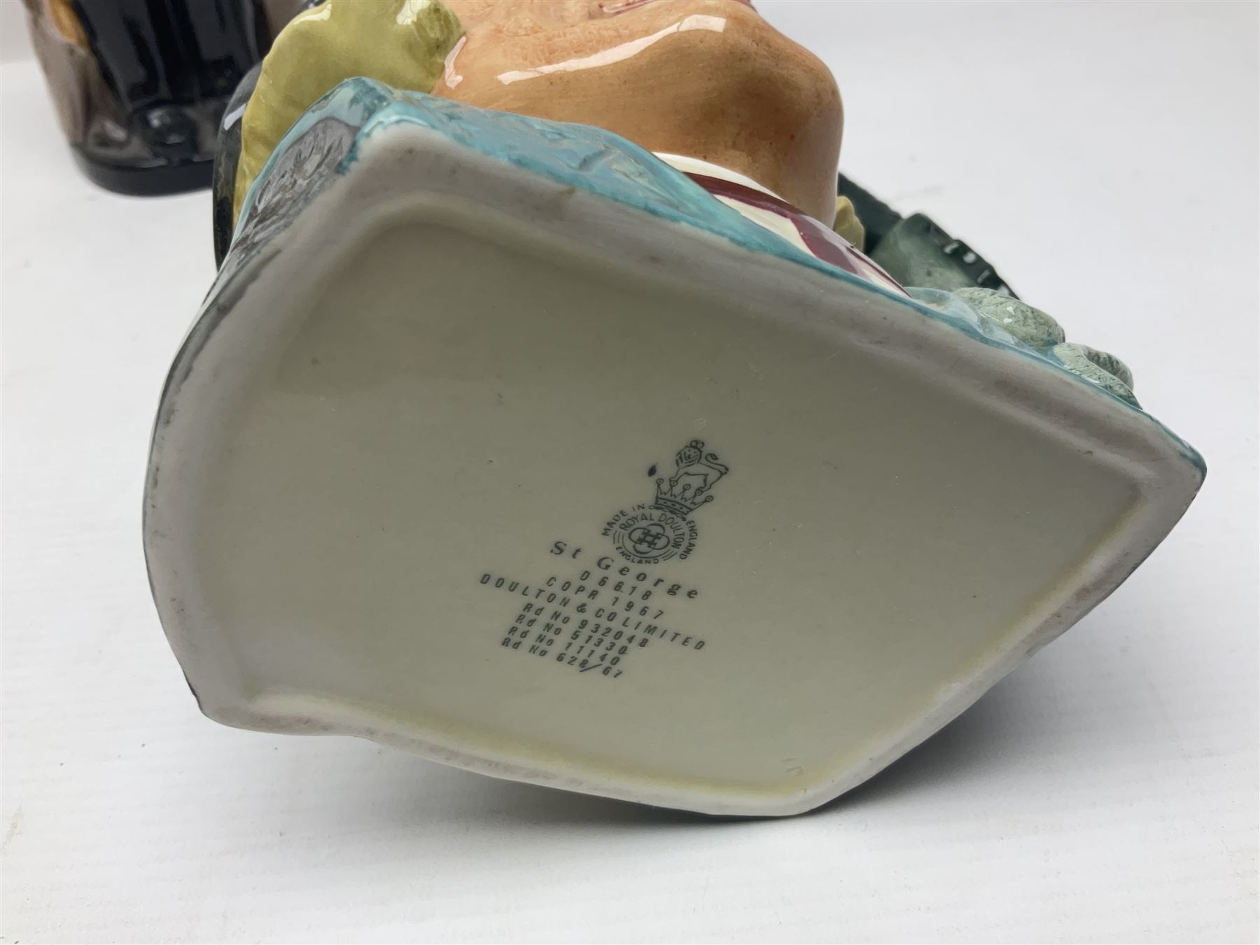 Royal Doulton Sir Winston Churchill figure HN3057, together with Winston Churchill toby jug, and three character jugs 
