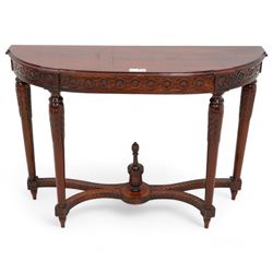 Mahogany demi-lune console table, moulded top over flower head guilloche decorated frieze, on turned and acanthus carved supports with fluted decoration, united by shaped stretchers with central finial 