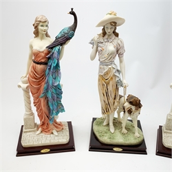  A pair of La Anina Collection figurines, each modelled as a female figure in pink dress supporting a peacock on one arm, and resting the other upon a classical column, H51.5cm, together with another similar figurine modelled as a female figure with hound at her side.   