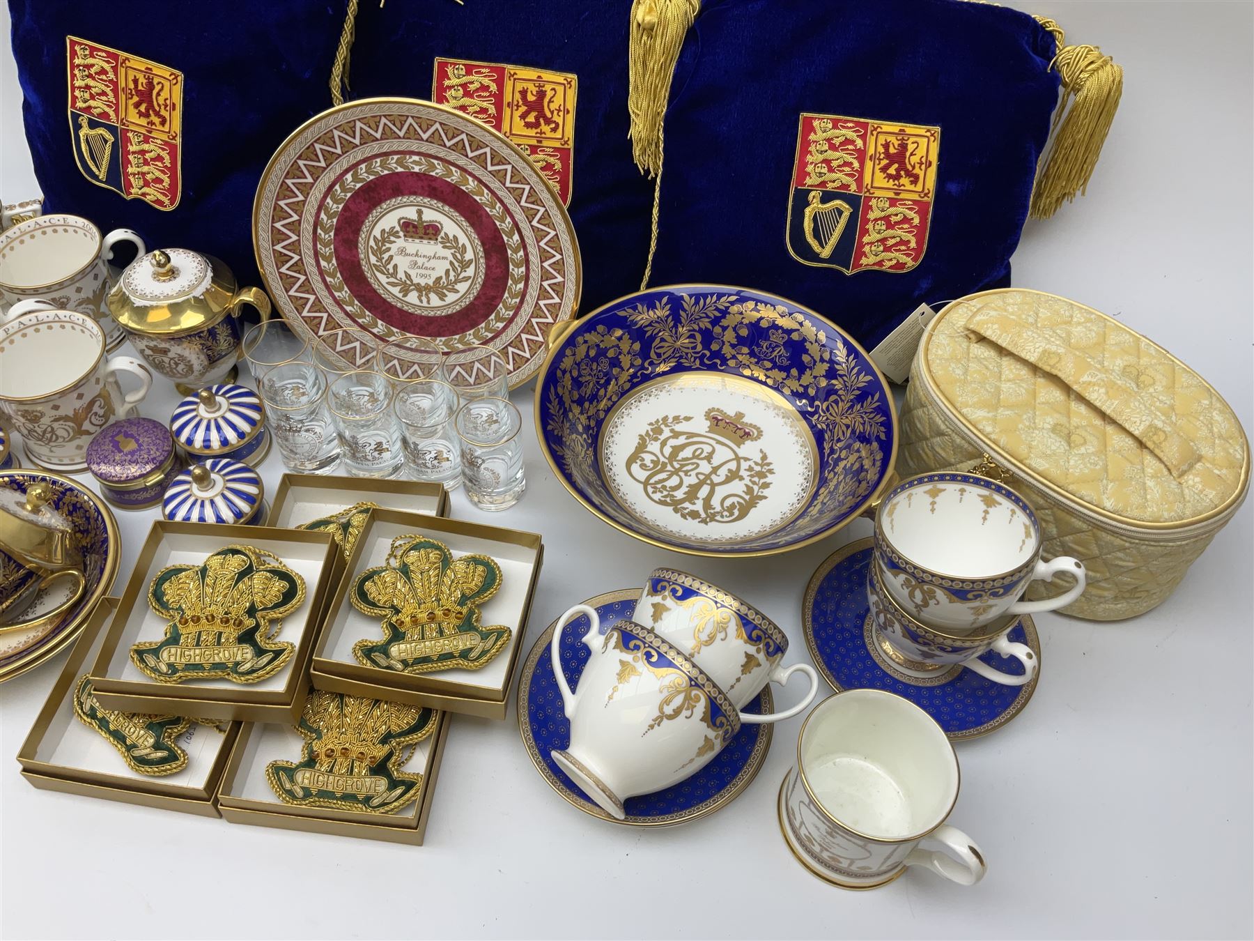 Commemorative ware Including five green and gold Highgrove limited edition hand embroidered tree decoration, a collection of ceramic ware from the royal collection including four cups and saucers, small teapot,    three trinket trays, five trinket pots with lids, eight tot glasses, three William Edwards Queens 80th cup, Hudson & Middleton hinged box etc. 