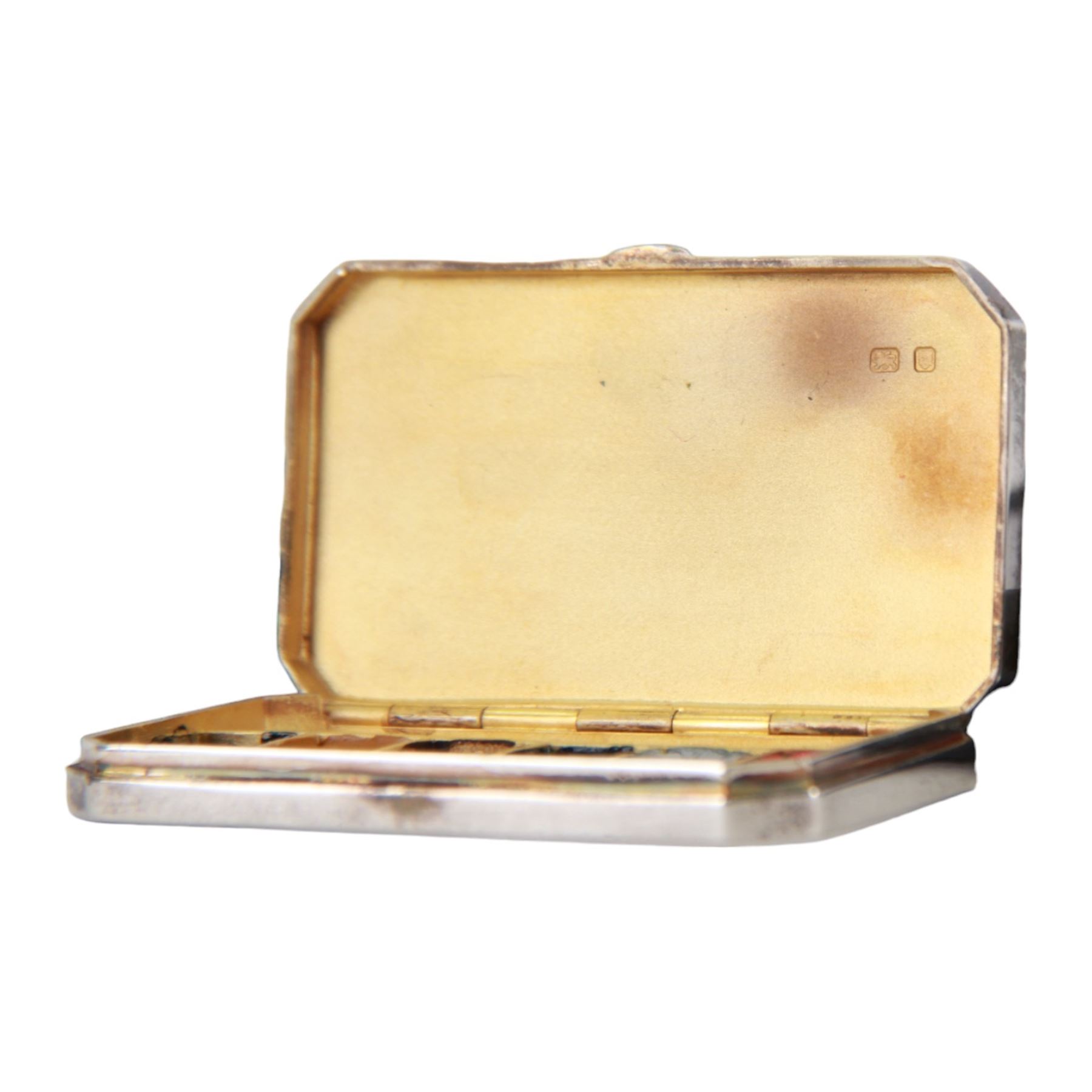 Modern silver miniature paint box, of plain rectangular form with canted corners, the hinged cover lifting to reveal a compartmented gilt interior containing twelve paints, hallmarked Sarah Jones, London 1986, L6cm