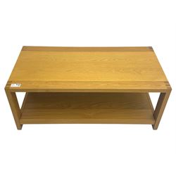 Light oak rectangular coffee table, with exposed finger joints to the corners, raised above a full-length undertier on straight supports