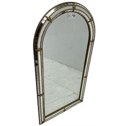 Arched top cushion framed wall mirror, decorated with gilt metal beading 