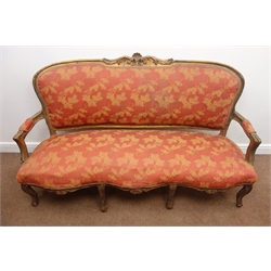  19th century gilt framed serpentine front settee, carved cresting rail, upholstered back, seat and arms with a red and gold floral fabric, cabriole supports, W170cm  