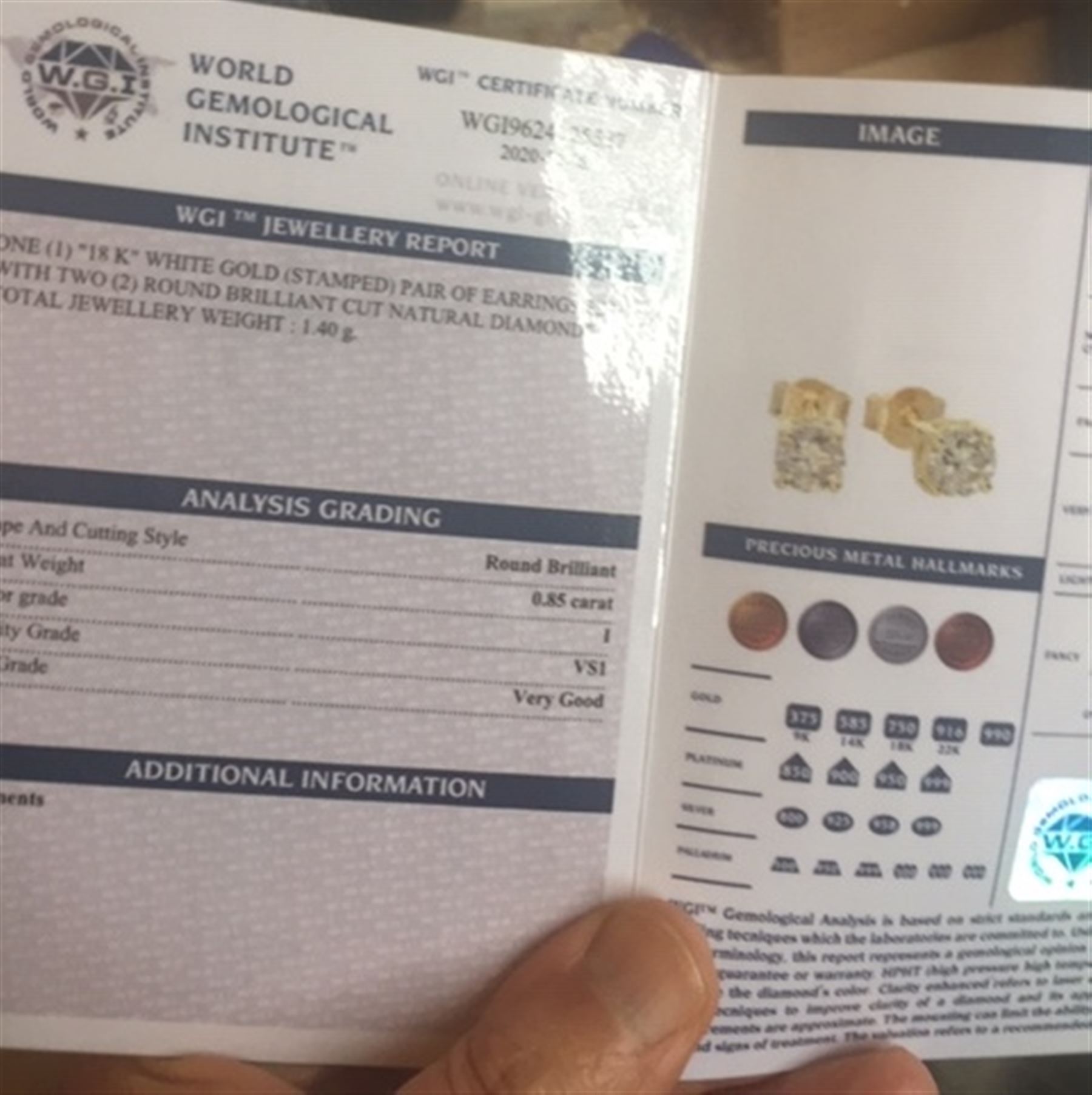 Pair of 18ct gold diamond stud earrings, stamped 750, total diamond weight 0.85 carat, with WGI certificate