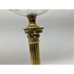 Victorian brass oil lamp, the square stepped base leading to a Corinthian column supporting a part slice cut clear glass reservoir, burner, clear glass chimney and foliate etched glass shade with amber rim, overall H80cm