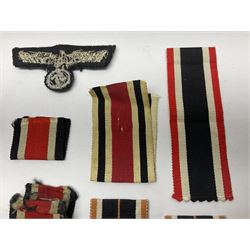 WWII German Iron Cross 2nd Class, the suspension ring stamped 128 for S. Jablonski G.m.b.H. Posen; with ribbon; together with an embroidered cloth eagle badge and quantity of German medal ribbons.