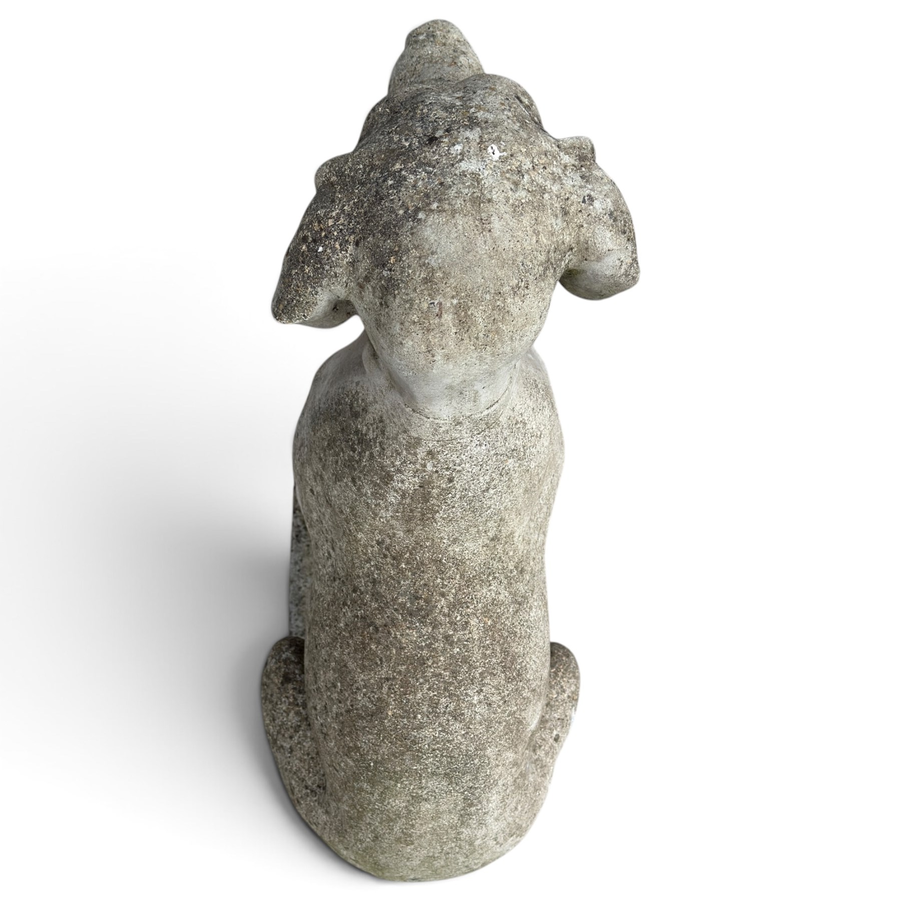 Weathered cast stone garden statue modelled as a seated pointer dog wearing a collar