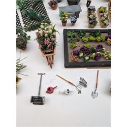 1:12 scale dolls house allotment and garden accessories, including wooden shed on a stone effect base, two vegetable patches, terracotta plant pots with flowers and foliage, stone effect plant pots, other planters, loose sunflowers, scarecrow, rabbit hutch, garden tools, fencing panels, etc 