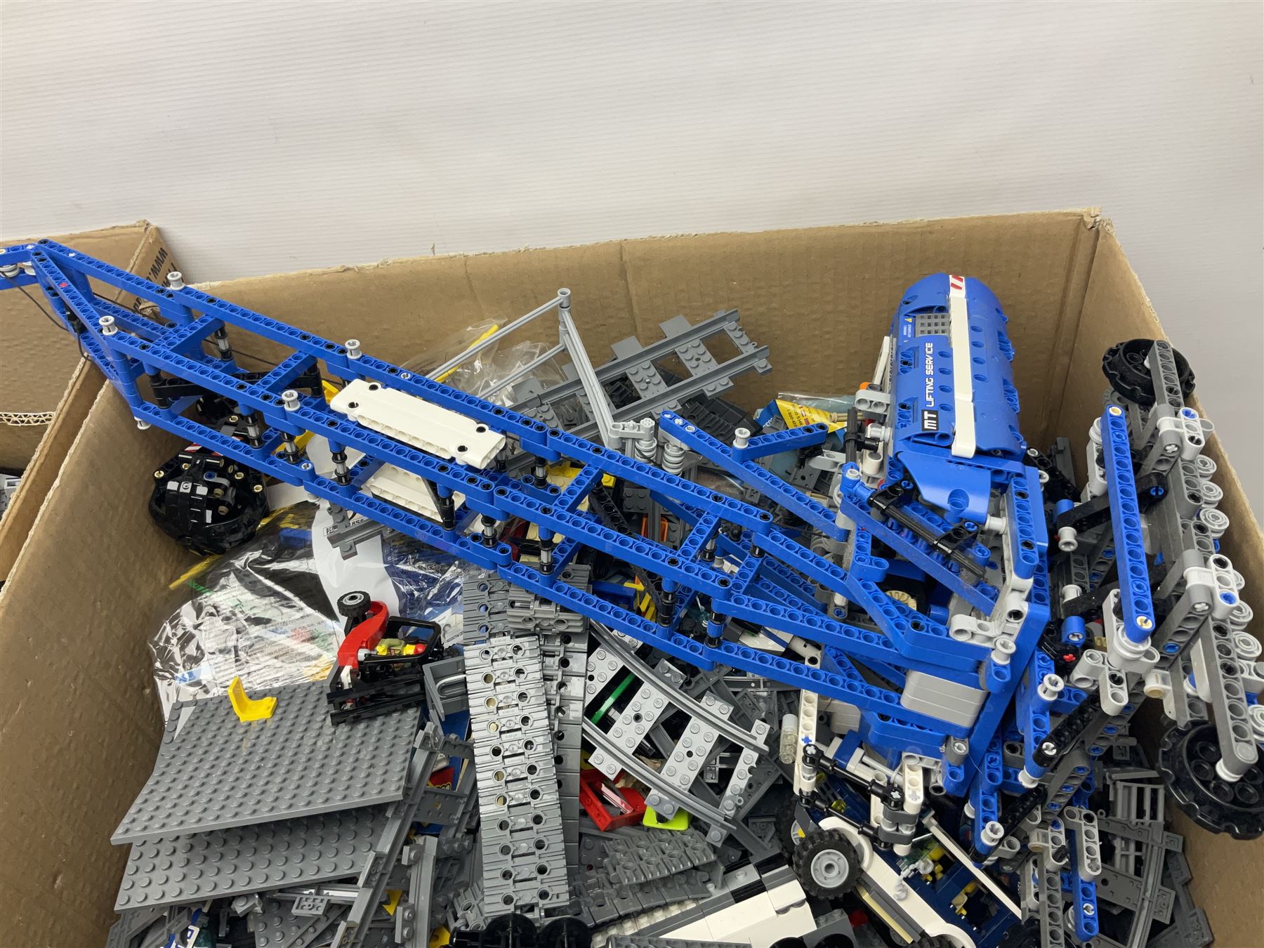 Very large collection of Lego, predominantly loose but some part constructed models, including Lego City, Lego Technic, Chima, Arctic 5, train set, mobile crane etc; together with numerous instruction booklets and some empty boxes; contained in two large cardboard boxes with gross weight of over 24kgs