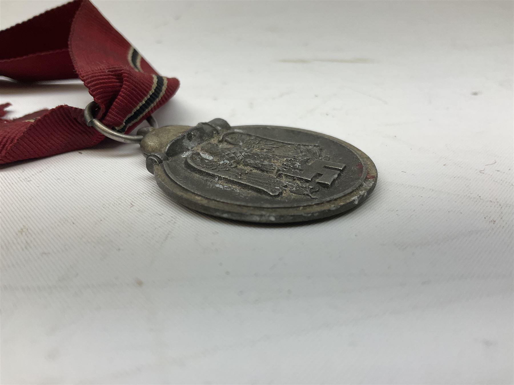 WW2 German Eastern Front Medal awarded to those who served on the German Eastern/Russian Front during the Winter Campaign period of 15th November 1941 to 15th April 1942 with original ribbon; and German War Merit Cross with swords 2nd Class (2)