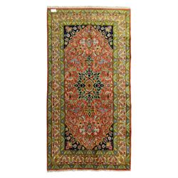South Persian Sirjan hand-knotted carpet, terracotta ground, with a central shaped dark na...