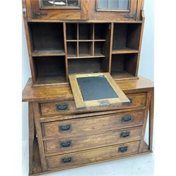Arts & Crafts oak cabinet on chest, projecting cornice above to lead glazed cabinet doors, two shelves flanking single fall front enclosing fitted interior, four graduating drawers