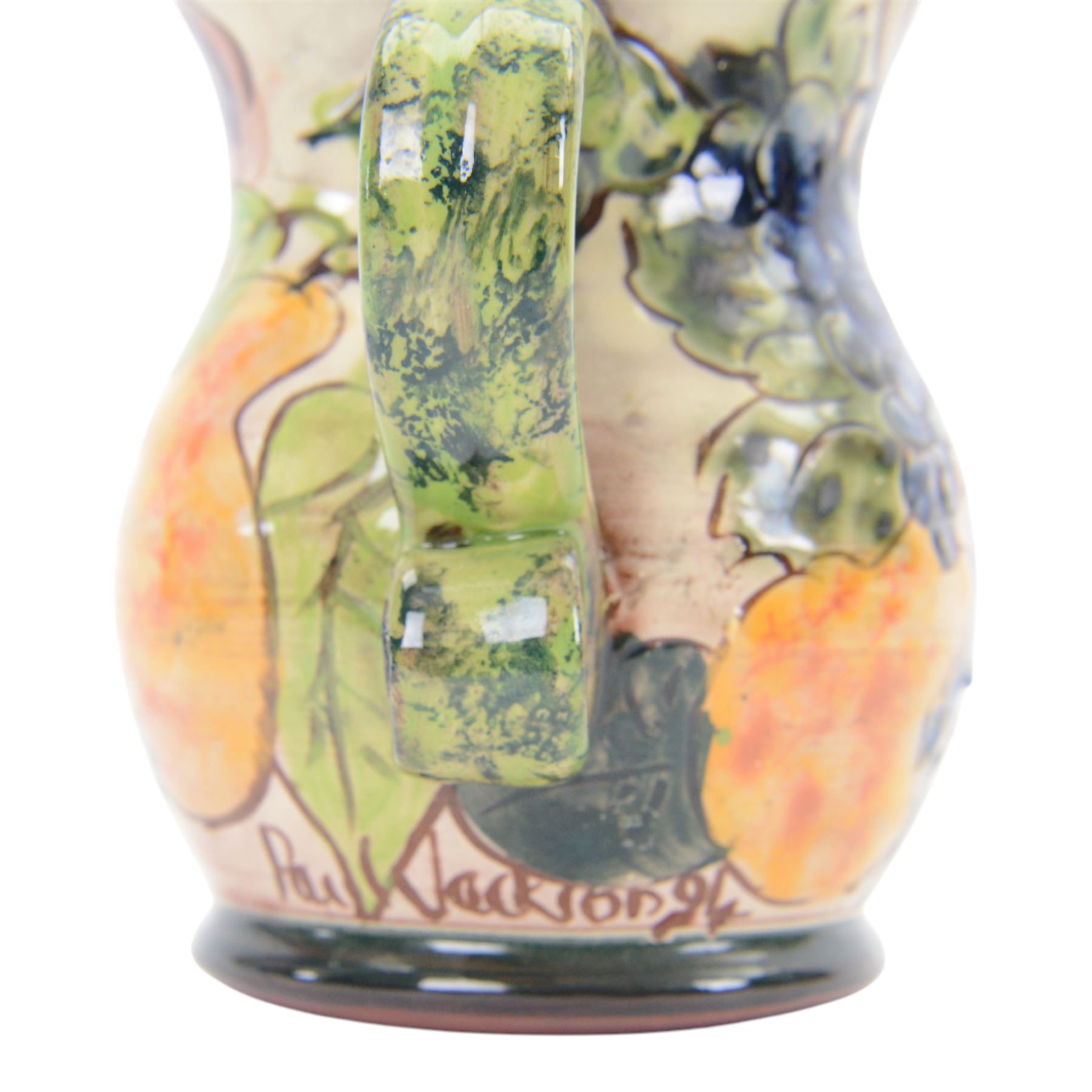 Paul Jackson Studio Pottery dished plate, decorated with Kingfishers and Koi fish amongst yellow irises, D26cm, together with a Paul Jackson Studio Pottery mug, of bellied form decorated with fruits, H11cm, each signed and dated 1996 and 1994