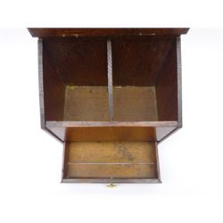 Early 19th century oak candle box, the shaped and pierced raised back above a sloped hinged lid opening to reveal a twin compartmented interior, above a single pull out drawer with ring handle, H38cm W25cm D15cm