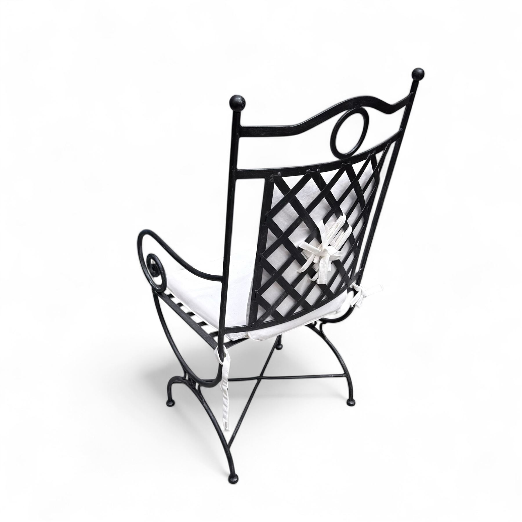 Wrought steel rectangular conservatory dining table, with glass top; and six, four side and two armchairs, with lattice backs and X framed bases, loose cushions