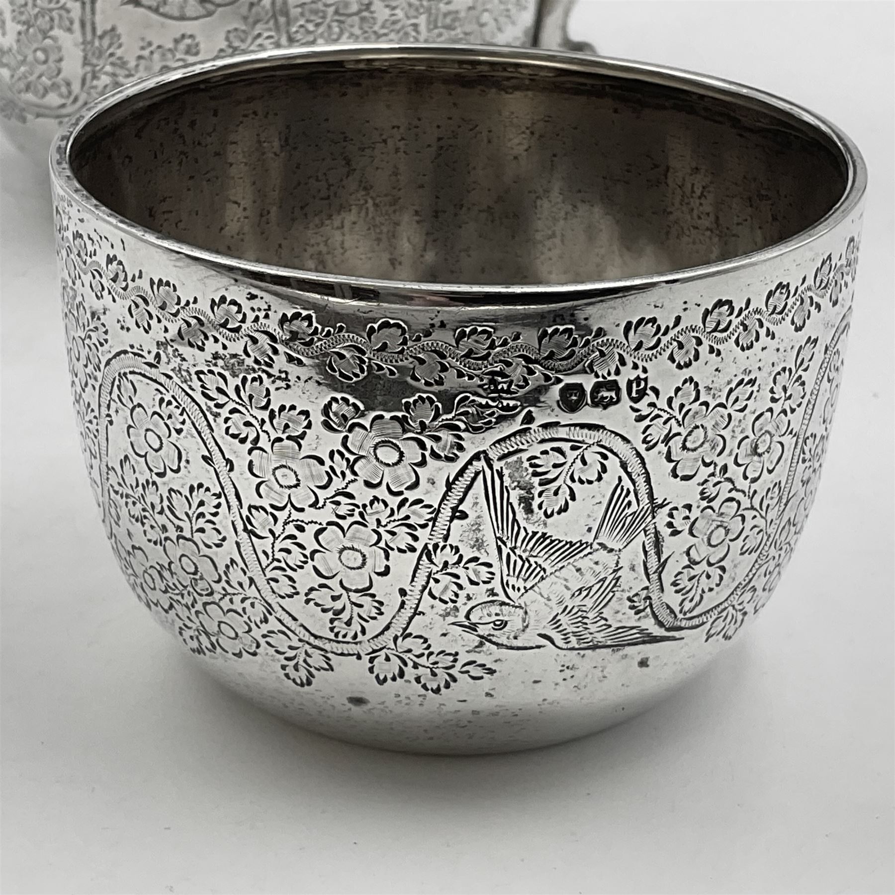 Late Victorian silver bachelors three piece tea service, comprising bullet shaped teapot, open sucrier and milk jug, each engraved with monogram surrounded by birds upon and amidst a blossoming vine, the teapot with scroll capped curved wooden handle and wooden finial to cover, hallmarked Wakely & Wheeler, London 1890, teapot including handle H12cm, sucrier H5.5cm 