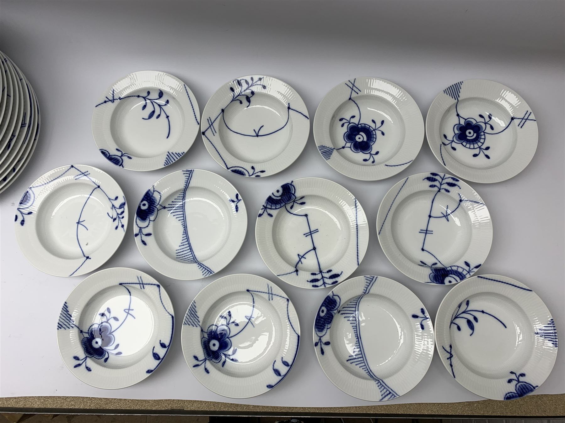 Royal Copenhagen tea and dinner service for twelve place settings, decorated in the Mega Blue Fluted pattern, pattern number 622, comprising dinner plates, salad plates, bowls with pierced rim, smaller bowls, tea cups, and saucers, dinner plates D27.5cm, salad plates D22cm