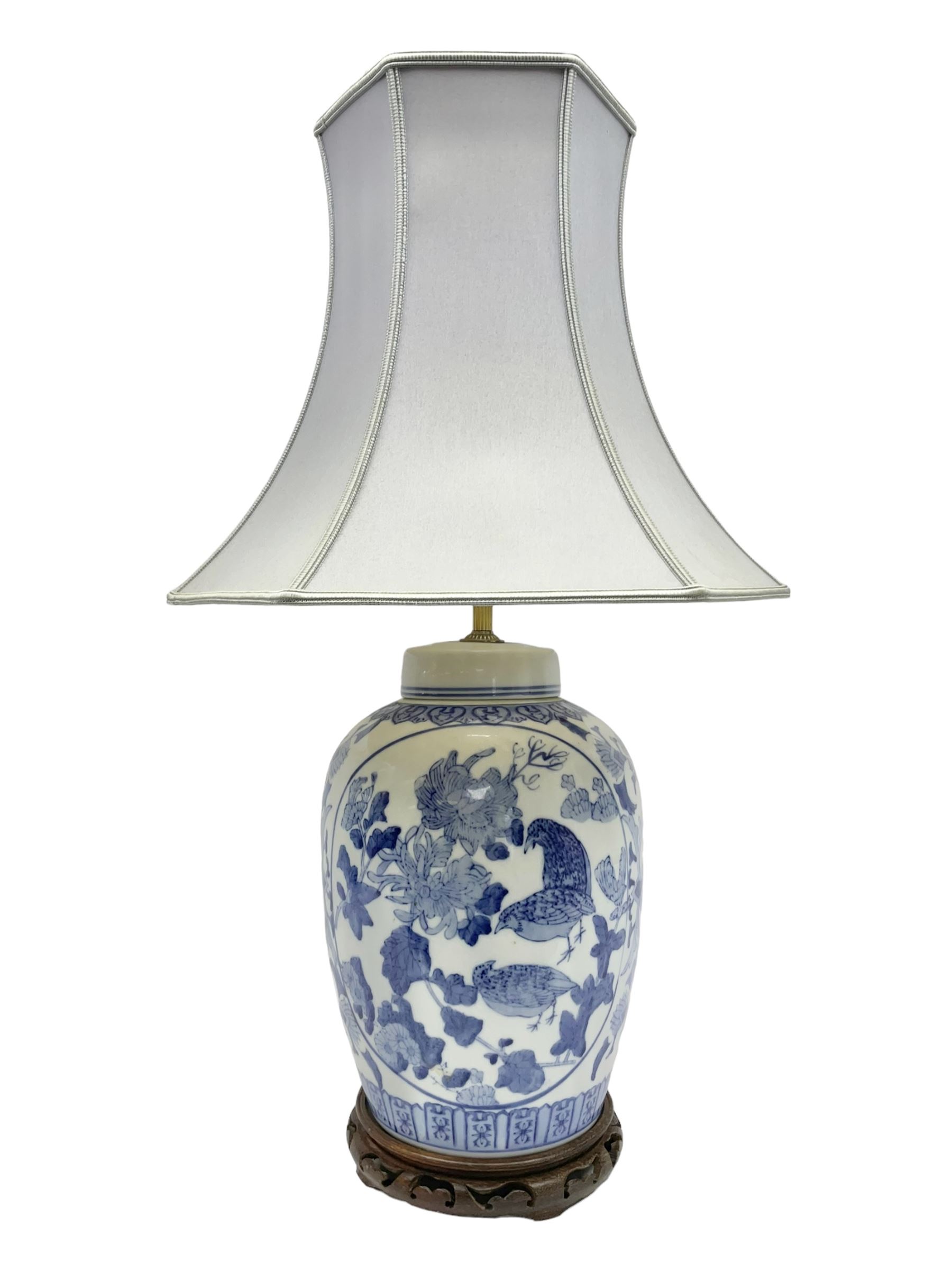 Chinese blue and white table lamp of baluster form, decorated with birds and floral displays, on hardwood base with shade, H78cm