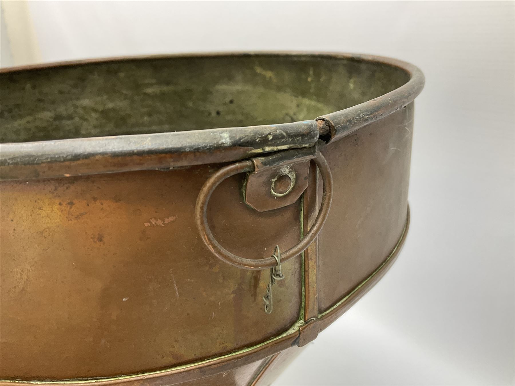 Agricultural copper corn funnel, H32.5cm, another similar copper funnel and copper warming platter of oval form, with twin handles on four supports, with removeable warming plate, L49cm