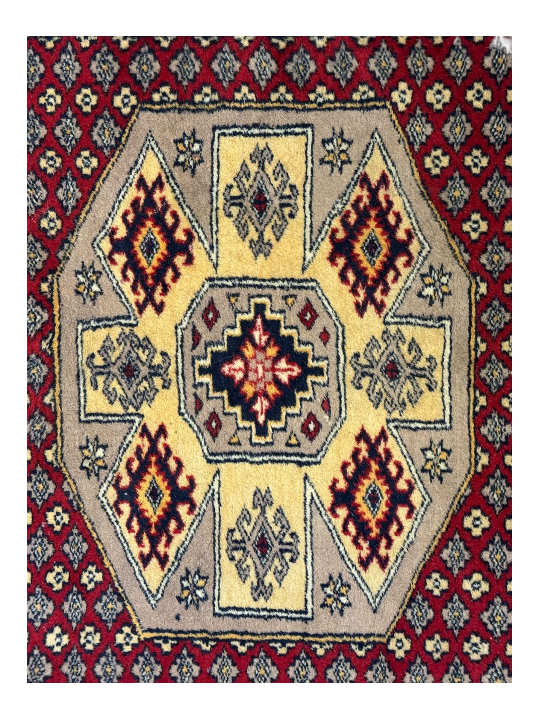 Pakistani Kashan hand-knotted rug with a central medallion and intricate geometric floral patterns, set against a red field and framed by a multi-band border (156 x 94cm); Pakistani Kashan rug with a repeating floral motif across the red field, enclosed by a detailed geometric border in complementary tones (162 x 95cm)