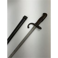 French Model 1874 epee/gras bayonet the 52cm steel piped back blade inscribed St. Etienne Avril 1877, in original scabbard, both numbered 17101, L66cm overall