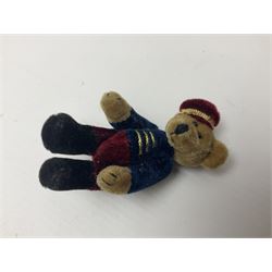 Group of five teddy bears comprising ‘George’ a unique pellet filled bear with glass eyes and velvet paws H38cm, and ‘Abbey’ a luxury German plush with wobble head and glass eyes no.5/10 H24cm, both with Teddies from Bearyland labels; along with two light blonde mohair H. M. Bears and Boyds Bears ‘T. F. Wuzzies’ no. 595140 (5)