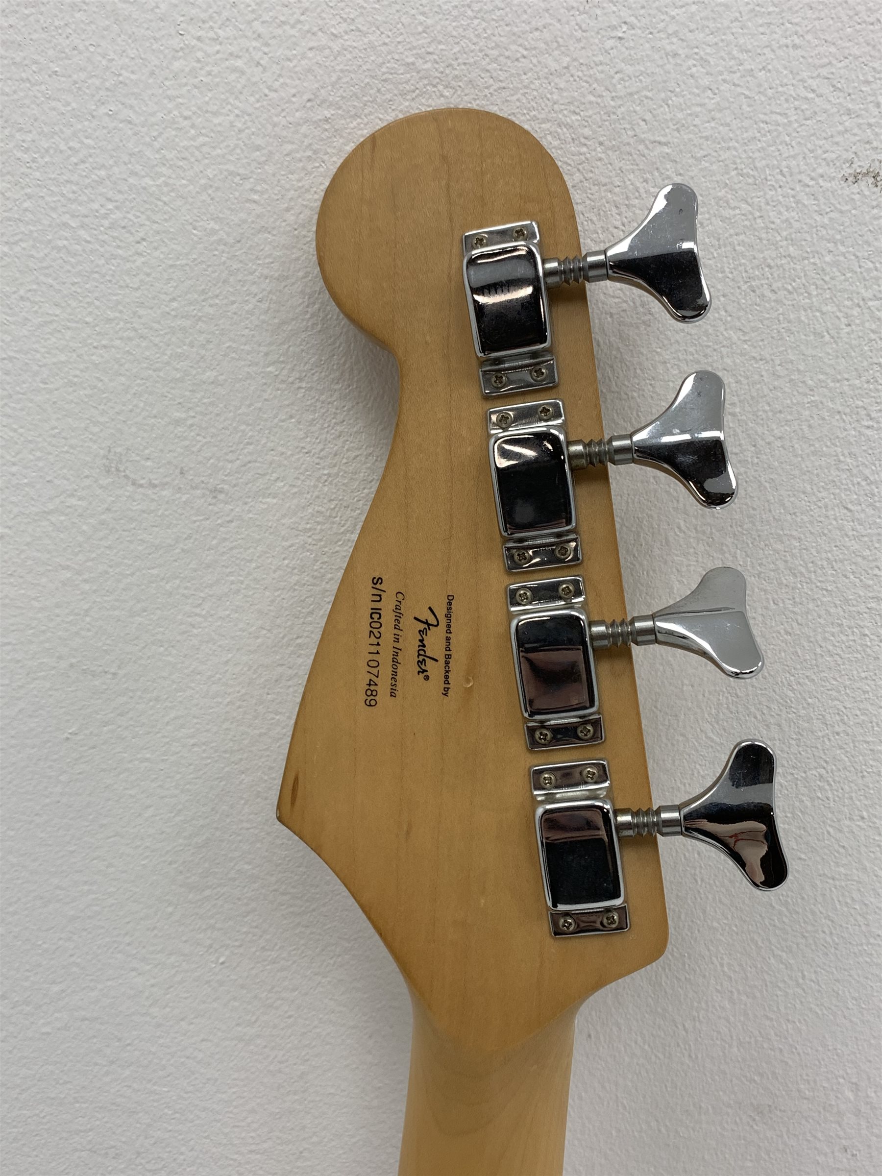  Fender Squier Bronco Affinity Series electric bass guitar, in black and white, serial no. IC021107489, L108cm, in associated Squier soft carrying case. From the collection of the late John Burgess of Beverley who played in the bands Penjants, Wine, Strollers, Revox, Sound Foundation, Pickle Belly Alley, Ragamuffins and Jerryattricks.