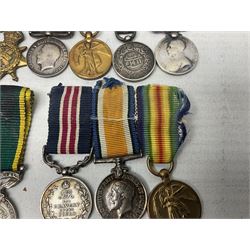 George V Military Medal and Distinguished Conduct Medal miniature group of seven medals comprising MM, DCM, WW1 trio including 1914 Star with date clasp and MID leaves, The Great Durbar Delhi 1911 Medal and LSGC; on pinned wearing bar; WW1 Military Medal miniature group of three comprising MM, BWM and Victory; Victoria North West Canada 1885 miniature; and George VI miniature Territorial Efficiency medal; all with ribbons