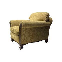 Early 20th century mahogany framed three-piece lounge suite - three-seat camelback sofa (W203cm, D105cm); pair of matching armchairs (W95cm, D96cm); upholstered in neutral foliate pattern fabric, carved with trailing leafy branches, ball and claw carved feet with brass castors 