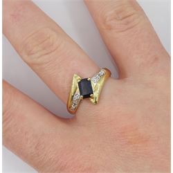 9ct gold emerald cut blue/black stone and diamond cross over ring, hallmarked 