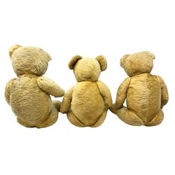 Large mid-20th century English teddy bear, the revolving head with applied eyes, vertically stitched nose and mouth and jointed body with growler mechanism H67cm; and two other similar large teddy bears (3)