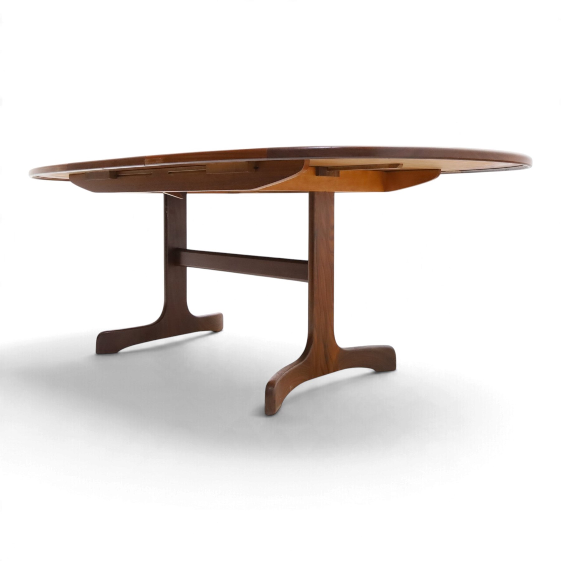 G Plan - Mid 20th century teak extending dining table and four chairs, oval top with stowed fold-over leaf extending to 208cm, raised on two shaped supports united by a stretcher 