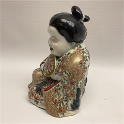 Japanese Fukusuke good fortune figure, modelled as a kneeling female figure holding a fan, dressed in traditional floral gilt robes, H16.5cm