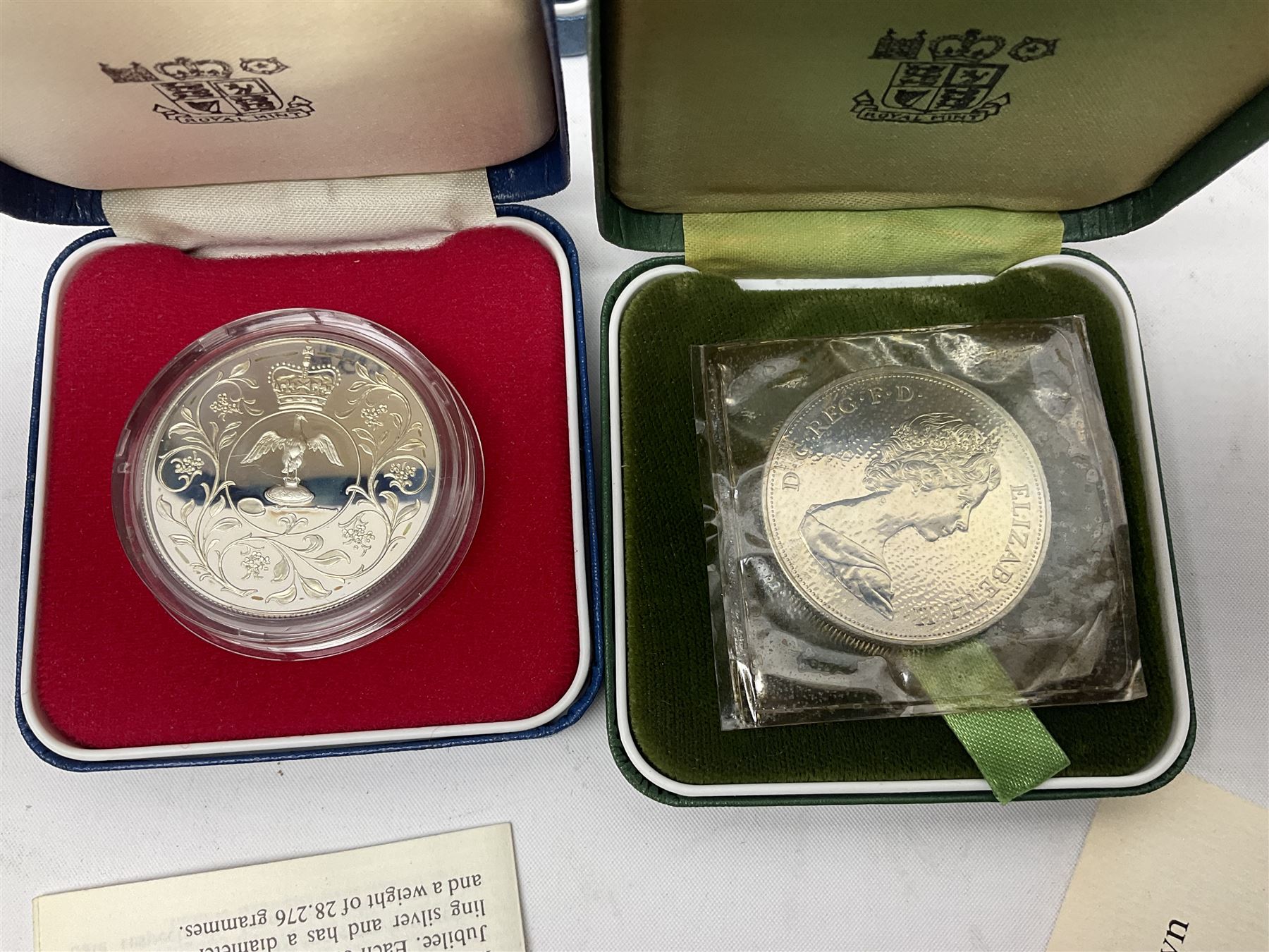 Seven The Royal Mint United Kingdom sterling silver proof crown coins, comprising two 1972, three 1977, 1981 and 1993, all cased with certificates and a Queen Elizabeth II 2001 one ounce fine silver Britannia coin on card (8)