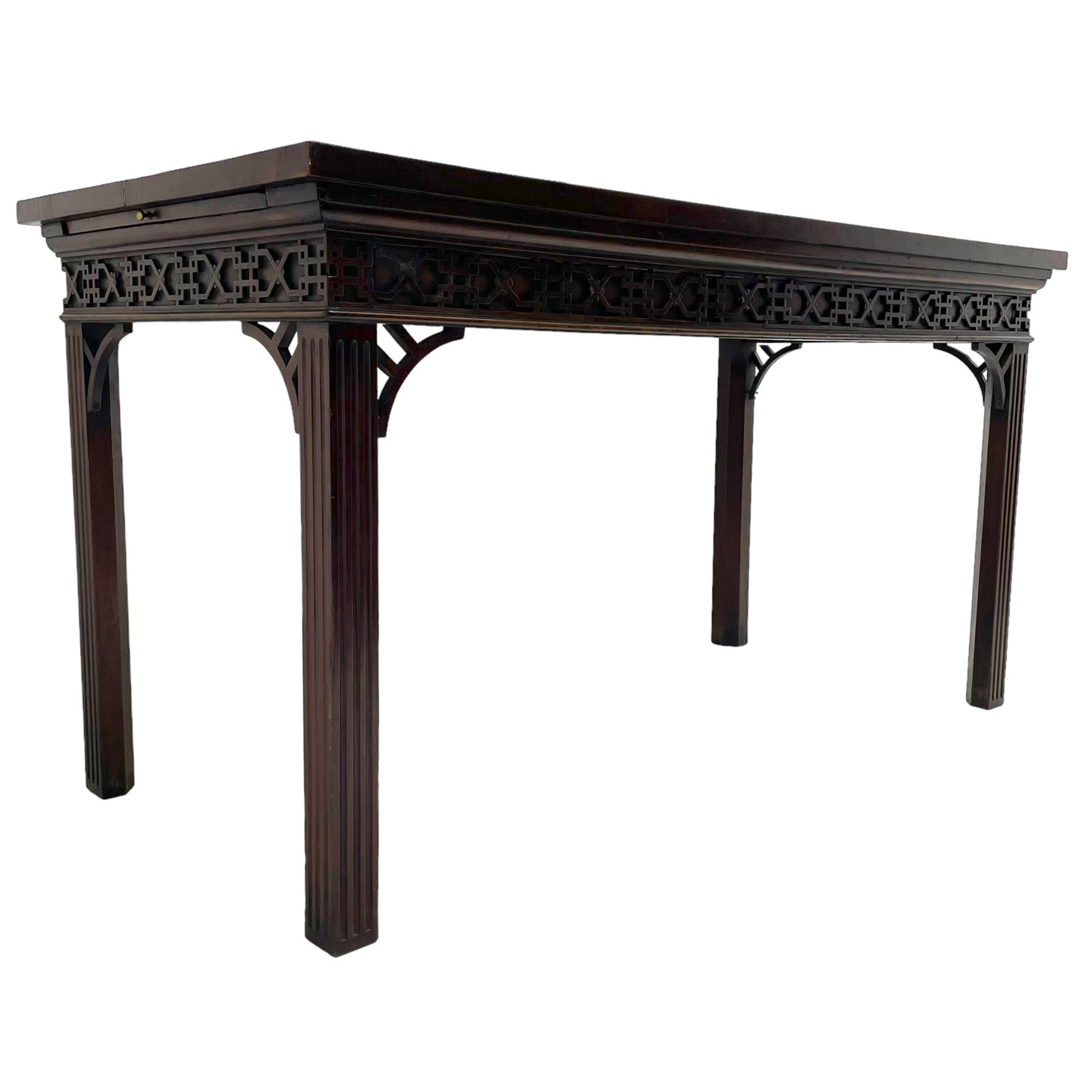 In the manner of Thomas Chippendale - early 19th century mahogany serving table, rectangular crossbanded top with boxwood stringing, the frieze with upper moulding over applied geometric fretwork, the left-hand side fitted with slide, on fluted square supports with inner chamfer 