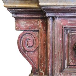 A 20th century Italian Neoclassical console table of monumental architectural form, inspired by Roman altar and sarcophagus prototypes; the rectangular marble top with dentil-moulded edge and polychrome geometric compass-star inlay, executed in contrasting marbles on a dark green ground, above a pedestal base of simulated stone finished in red porphyry-type tones, centred by a lion’s mask in relief and flanked by Ionic scroll volutes, raised on a stepped plinth base