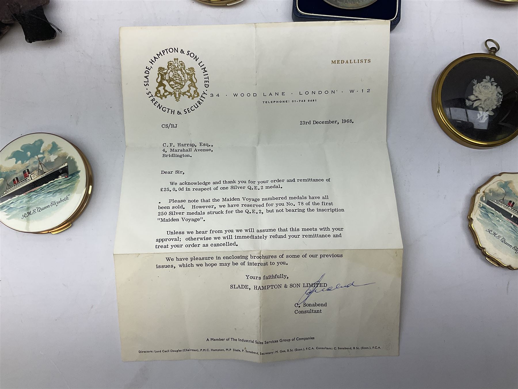 Silver 1969 Cunard RMS Queen Elizabeth maiden voyage commemorative medallion, in original Slade, Hampton & Son case with certificate, two Stratton R.M.S Queen Elizabeth mirror compacts, Stratton R.M.S Queen Mary compact, mid 20th century P&O Canberra Round World Voyage miniature globe, S.S Oriana ash tray modelled as a barrel, Norah Wellings sailor doll, and other maritime and shipping memorabilia 