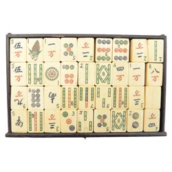 20th century Chinese Mahjong set, with five drawers containing bone counters and tiles, contained within a wooden box with brass detailing, together with a set of eight wooden Mahjong tile trays