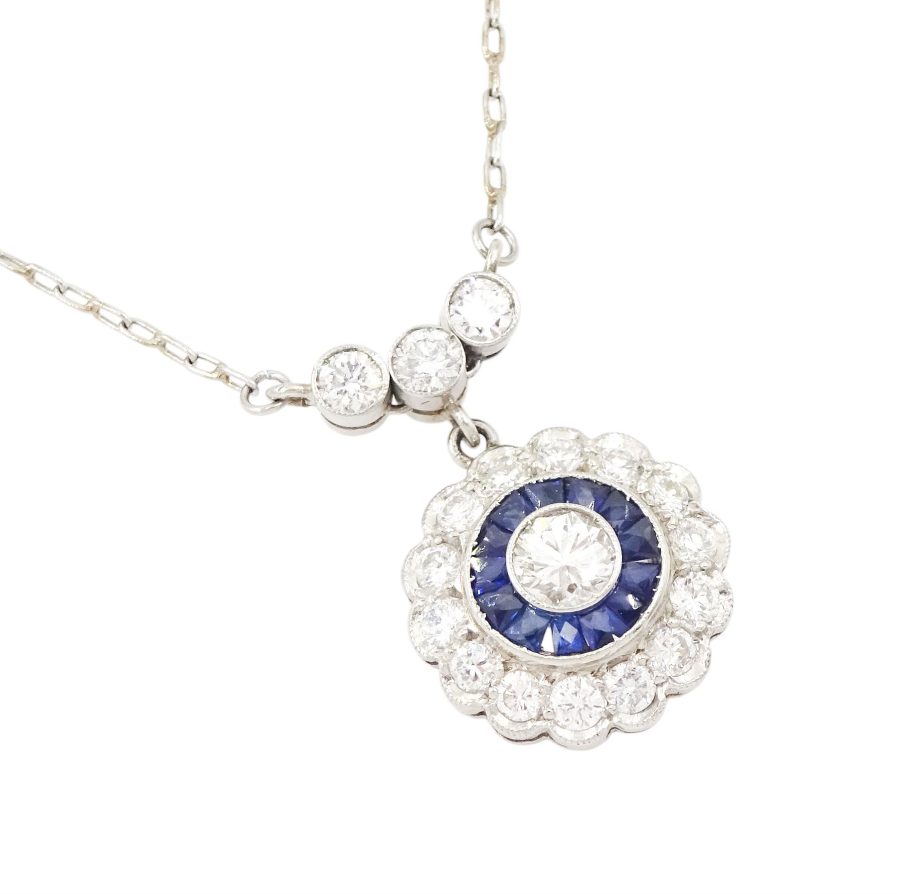 Platinum sapphire and diamond necklace, milgrain set round brilliant cut diamond and calibre cut sapphire cluster, suspending from three round brilliant cut diamonds, to a trace link chain necklace, total diamond weight 0.65 carat, total sapphire weight approx 0.30 carat