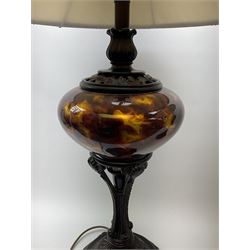 Two large bronzed composite table lamps, with central marbled tortoiseshell effect bodies supported upon foliate detailed stems and spreading bases, with fabric shades, overall H96cm. 