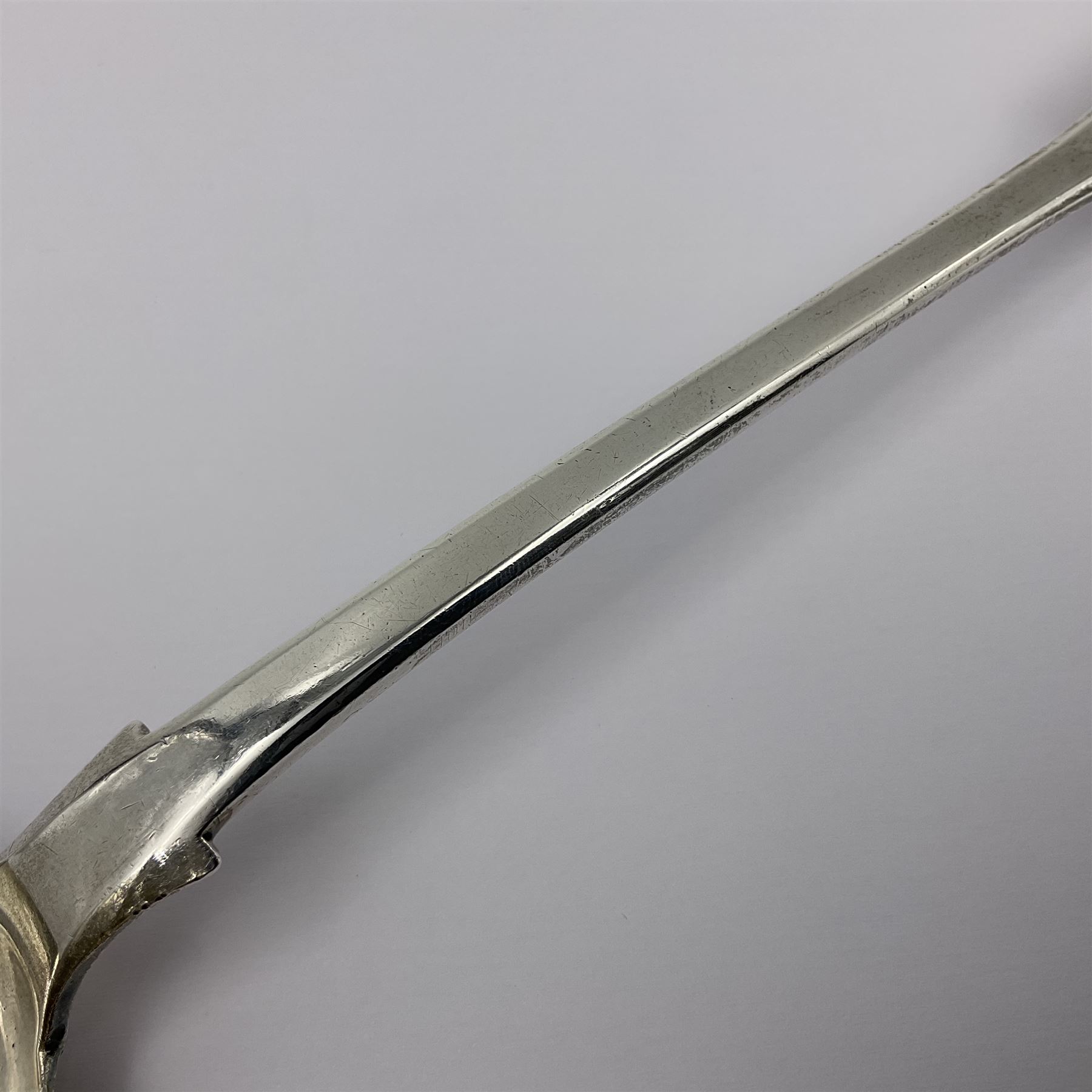 Victorian Newcastle silver Fiddle Shell pattern serving spoon, the terminal engraved with crest of a fist holding an arrow aloft, hallmarked Lister & Sons, Newcastle 1862, L31cm
