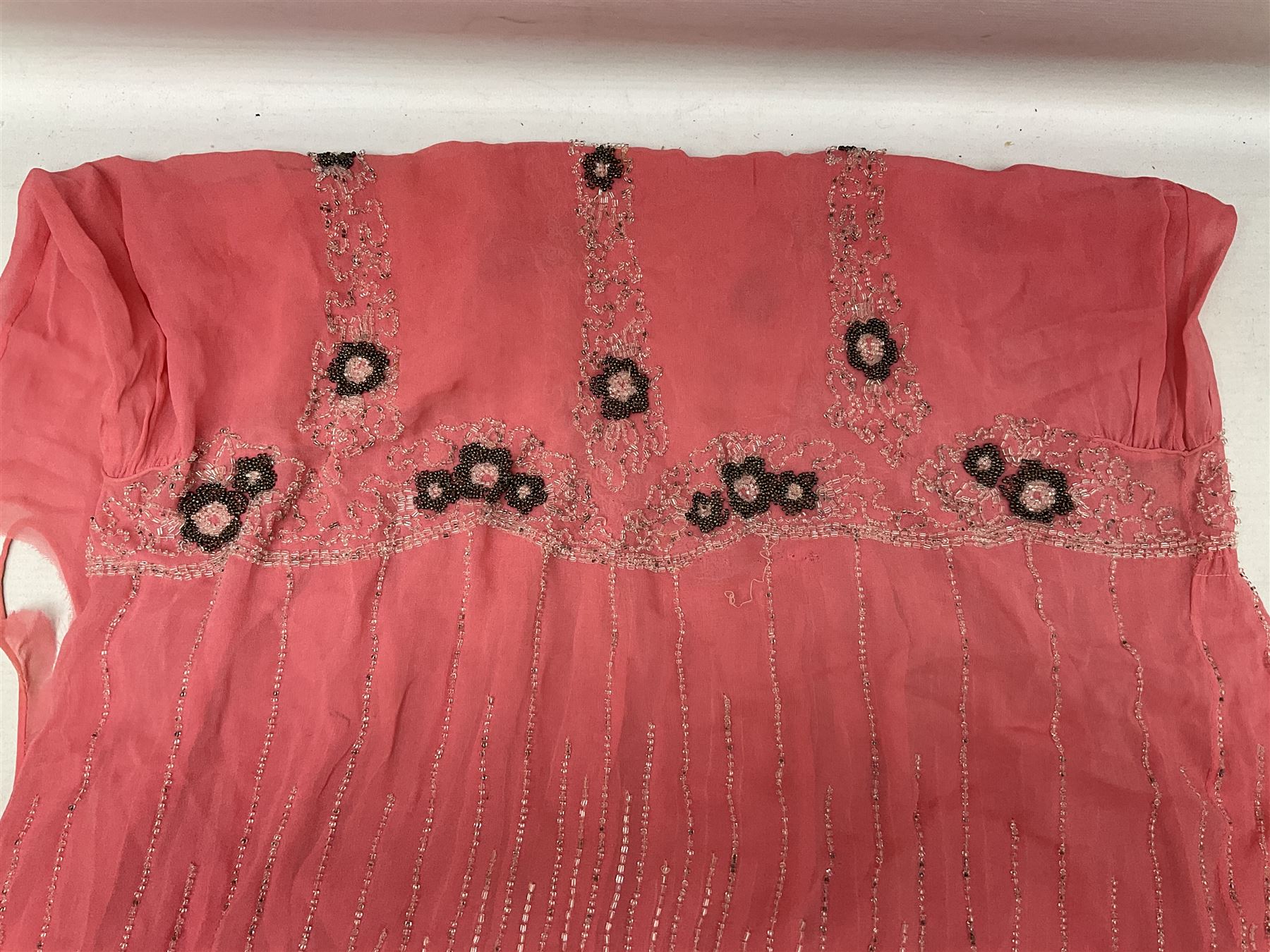 Art Deco pink flapper type beaded dress, with floral motifs and tasselled clear and black beadwork throughout