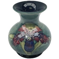 Moorcroft vase, decorated in the Leaf and Berries pattern upon a tonal green ground, together with a further Moorcroft vase, of squat baluster form, decorated in the Iris pattern upon a tonal green ground, each with impressed marks beneath, each H9cm. 