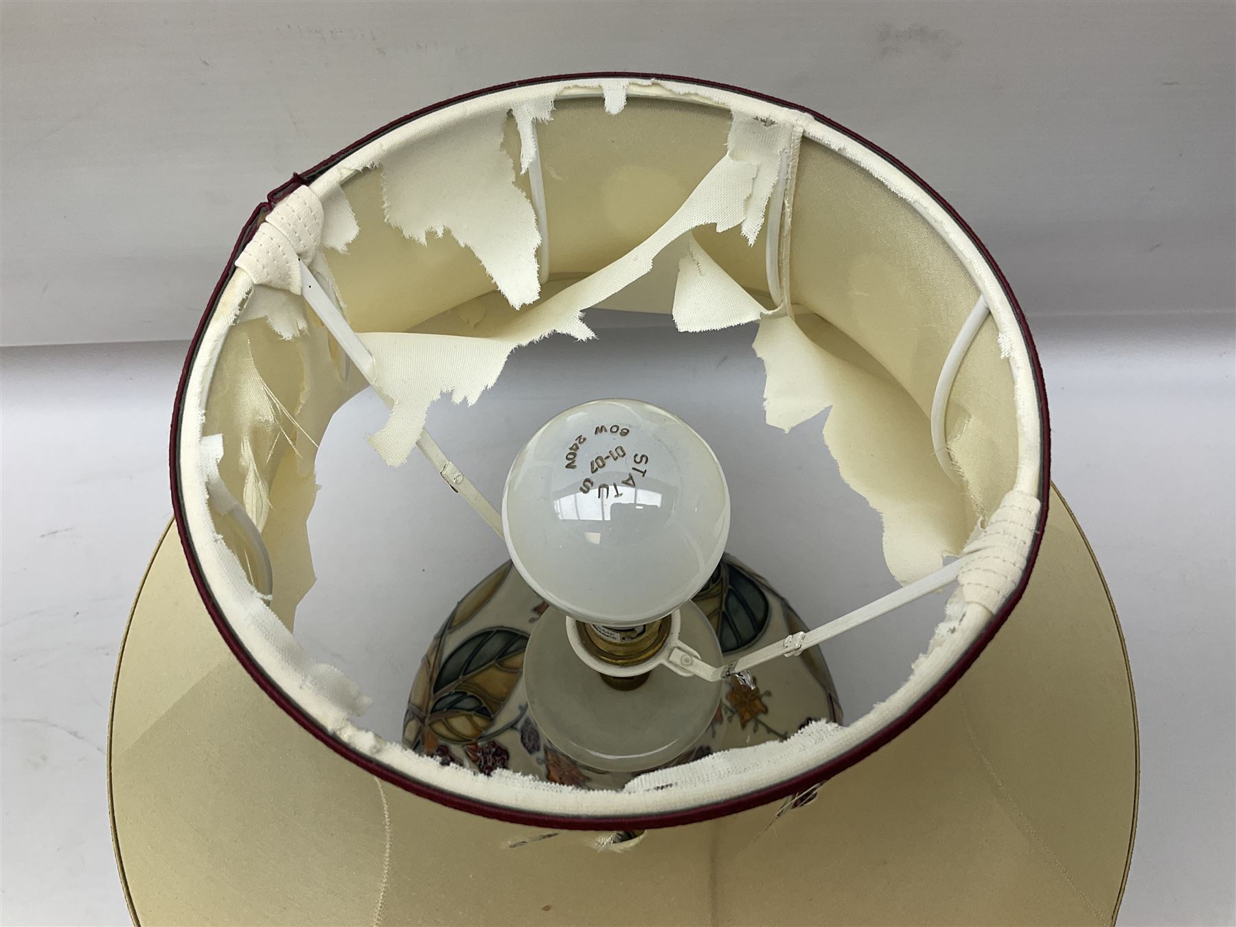 Moorcroft table lamp of squat baluster form, decorated in the Autumn Blackberry, with Moorcroft cream fabric shade with gold, green and red piping, overall H38cm