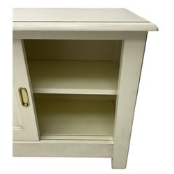 Cream finish low side cabinet, moulded rectangular top over two sliding panelled doors, on stile supports 