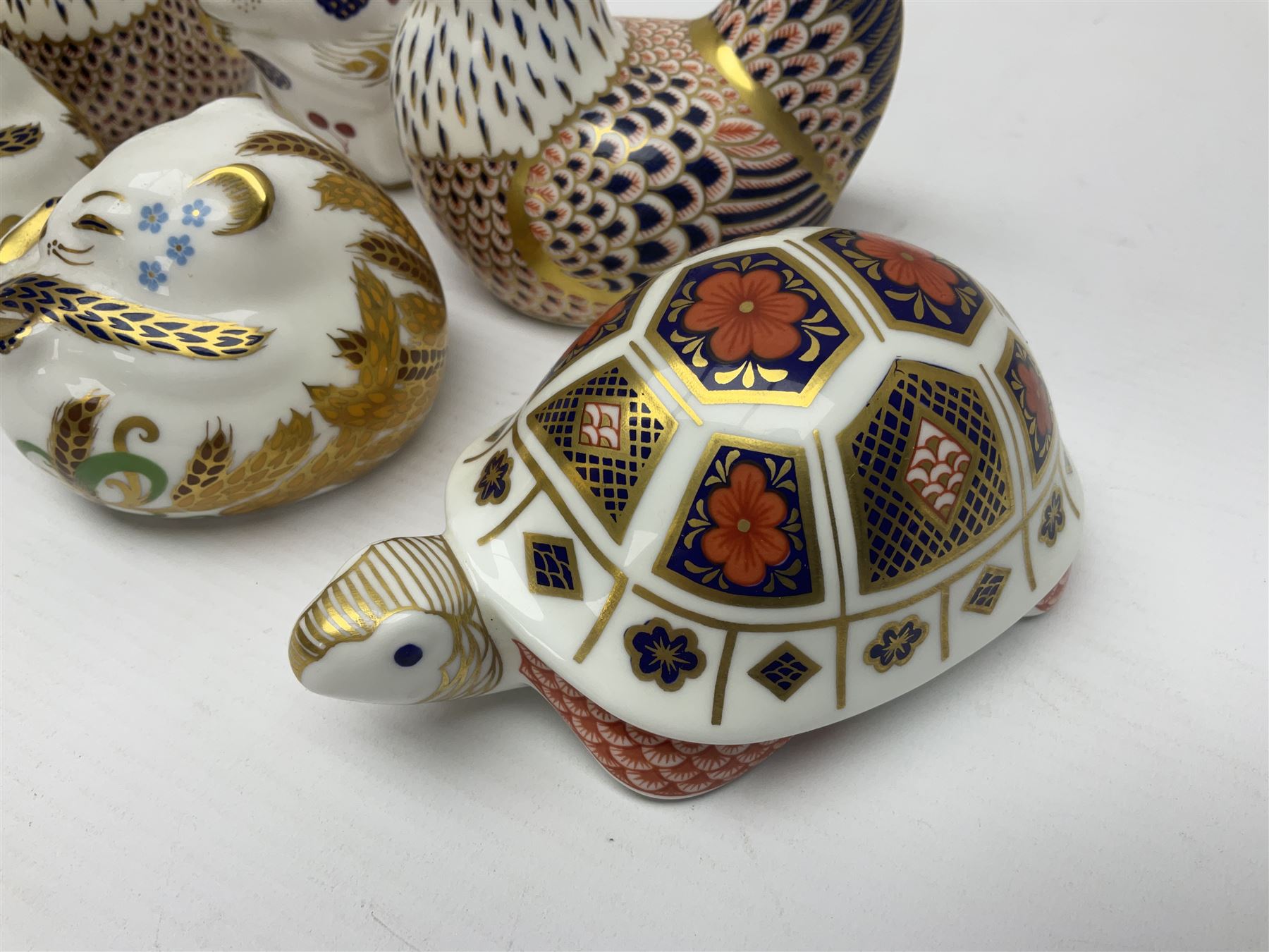 Seven Royal Crown Derby Paperweights, to include Field mouse with silver stopper, Dormouse, Chicken etc,  six without stoppers   