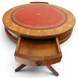 Regency style mahogany drum table, circular red leather inset top with gilt and blind tooling, bird's-eye maple crossbanded border, fitted with two opposing pull-out slides, on turned pedestal and three outswept support